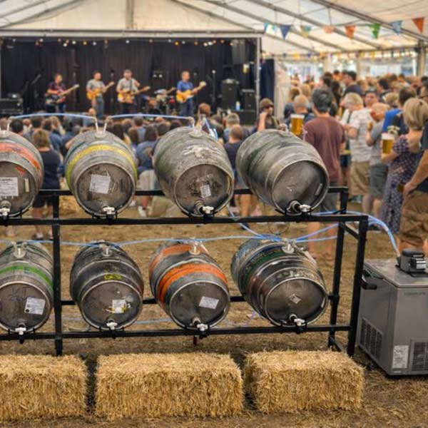 Concept image of a beer festival set-up with kegs of beer in the foreground